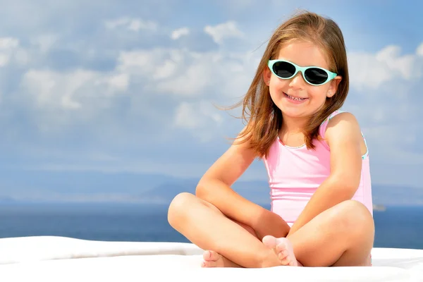 Toddler girl on sunbed — Stock Photo, Image