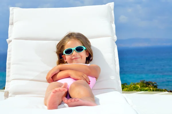Toddler girl on sunbed — Stock Photo, Image