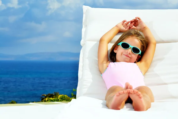 Toddler girl on sunbed — Stock Photo, Image