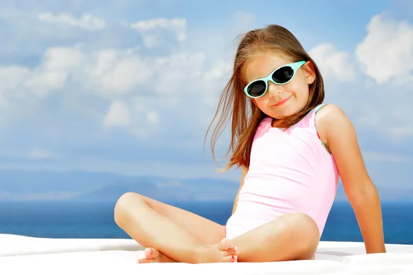 Toddler girl on sunbed — Stock Photo, Image