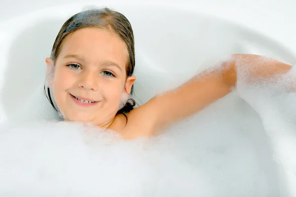 Girl playing with water and foam in a  bathtub — Stock Photo, Image