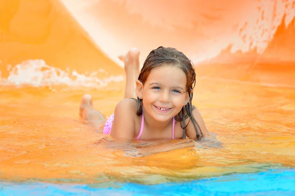 Adorabile bambina sullo scivolo d'acqua all'aquapark — Foto Stock