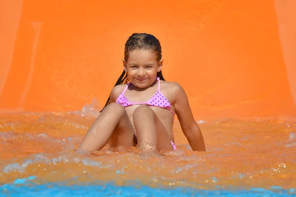 Adorable toddler girl on water slide at aquapark — Stock Photo, Image