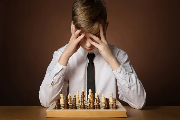 Concentrated serious boy developing chess gambit, strategy ,playing board  game to winner clever concentration and thinking child while playing chess.  Learning, tactics and analysis concept. 7292819 Stock Photo at Vecteezy