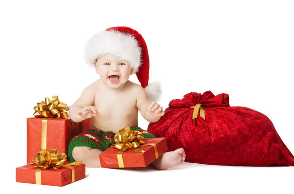 Karácsonyi baba gyerekek, jelen díszdobozban és Santa Bag, boldog gyermek mosolyogva a Red Hat a Xmas zsáknyi, elszigetelt fehér háttér — Stock Fotó