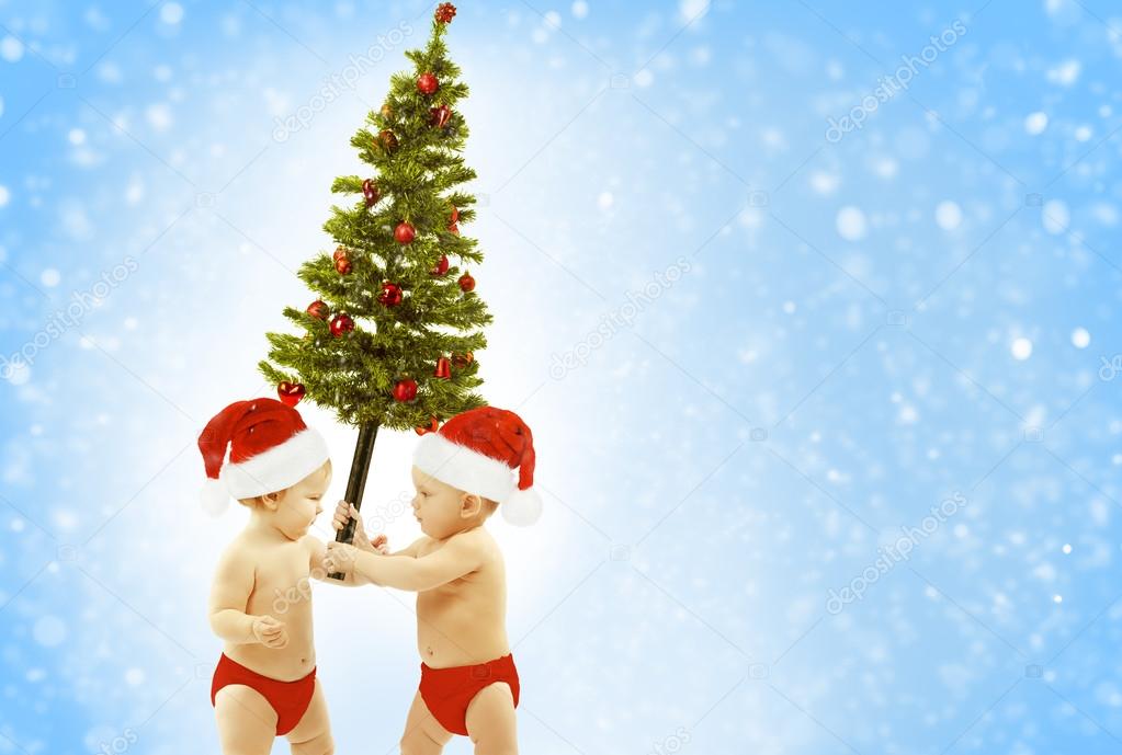 Christmas Baby Kids Greeting Present Xmas Tree, Children In Red Santa Hat Giving Fir As New Year Gift