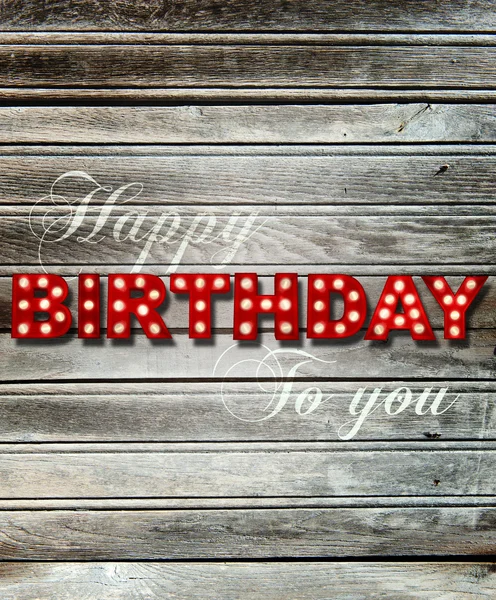 Glowing Happy Birthday on wooden background — Stock Photo, Image