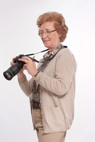 Senior dame met behulp van camera — Stockfoto