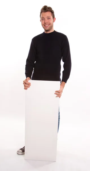 Jeune homme tenant un panneau vertical — Photo