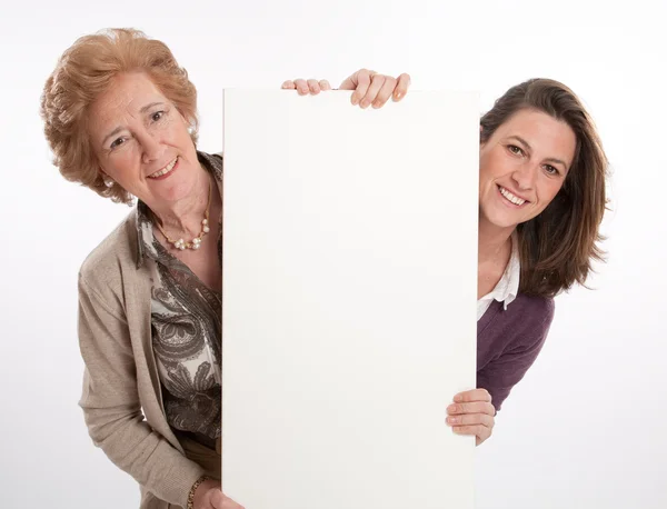 Woman and daughter holding blank board — Stock Photo, Image