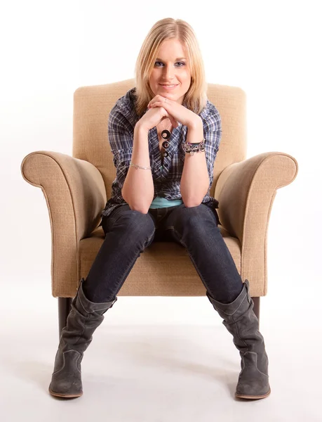 Girl sitting on armchair — Stock Photo, Image