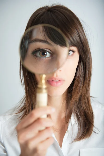 Girl with magnifying glass — Stock Photo, Image