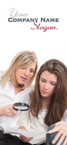 Girls examining document — Stock Photo, Image