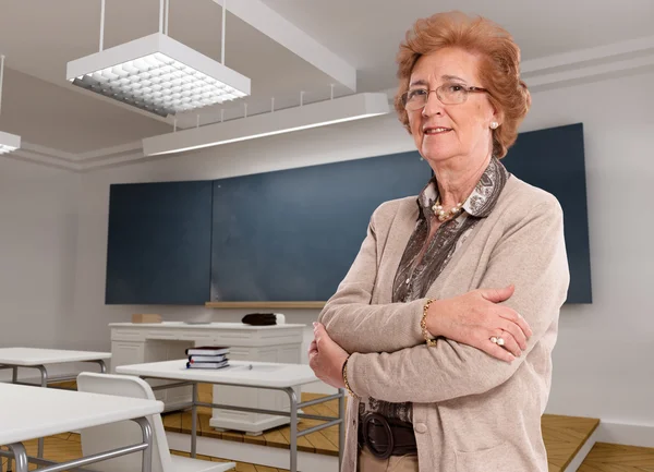 Senior lady in a classroom — Stock Photo, Image
