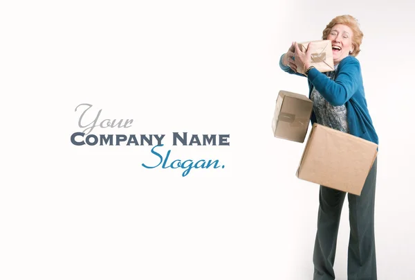 Senior woman with falling parcels — Stock Photo, Image