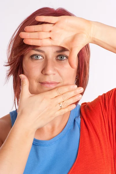 Woman framing her face with her hands — Stock Photo, Image