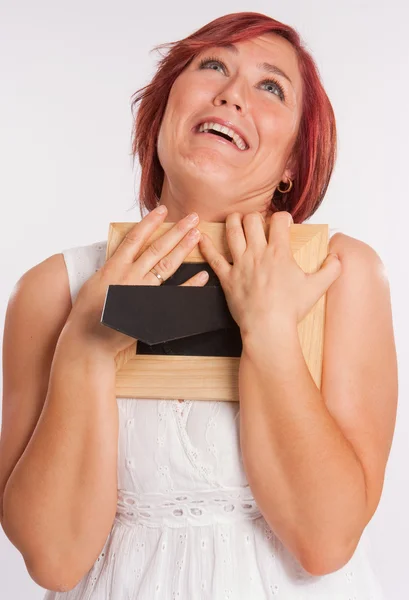 Woman embracing a picture frame — Stock Photo, Image
