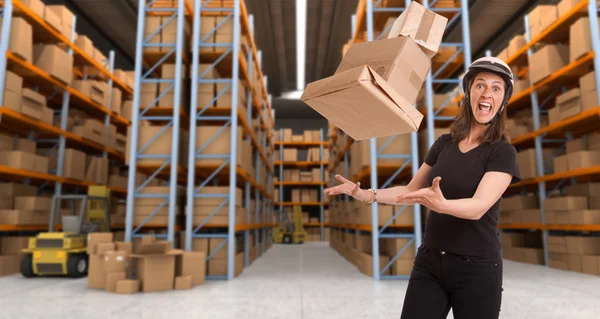 Crazy female courier at warehouse a — Stock Photo, Image