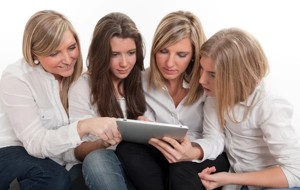 Friends around a tablet pc Stock Image