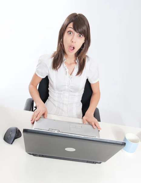 Surprised girl at her desk — Stock Photo, Image