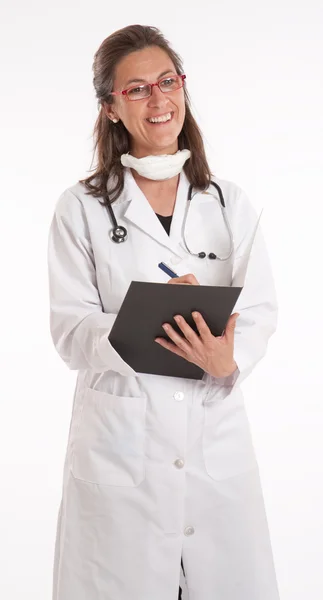 Cheerful female doctor taking notes — Stock Photo, Image