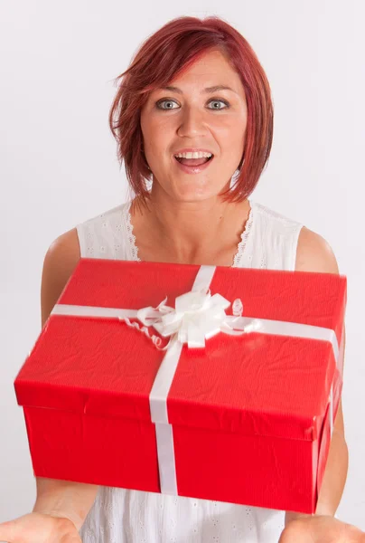 Red haired girl catching a present — Stock Photo, Image