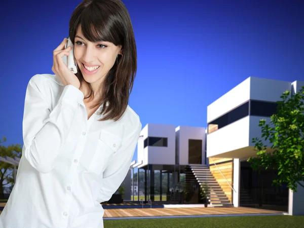 Woman on the phone by beautiful villa — Stock Photo, Image