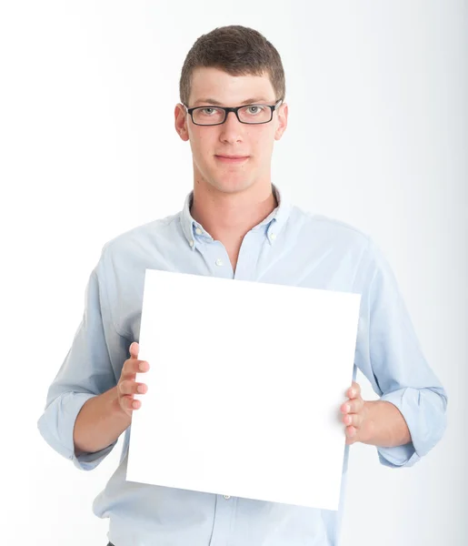 Young man holding a blank sign — Stock Photo, Image