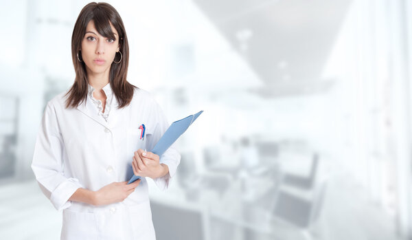 Standing woman in lab coat with folder
