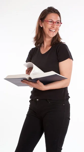 Laughing woman standing with book — Stock Photo, Image