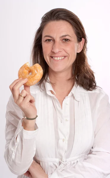 Happy woman eating a donut — Stock Photo, Image