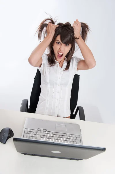 Desperate young woman with computer — Stock Photo, Image