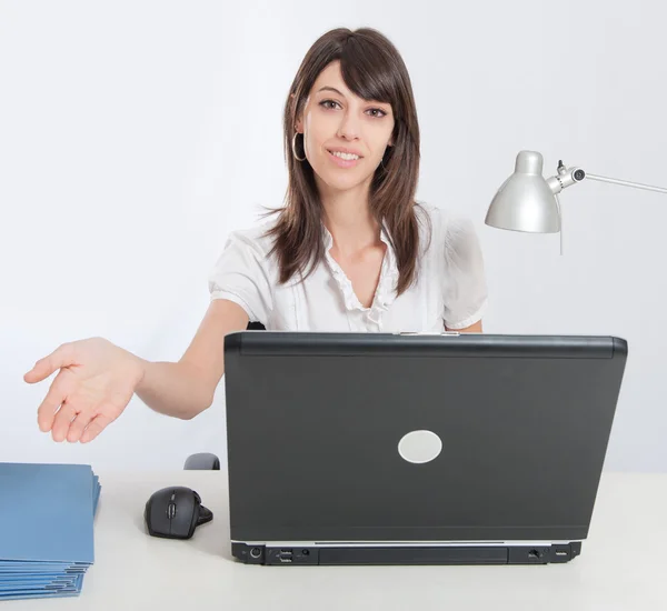 Woman at laptop extending her hand Royalty Free Stock Images