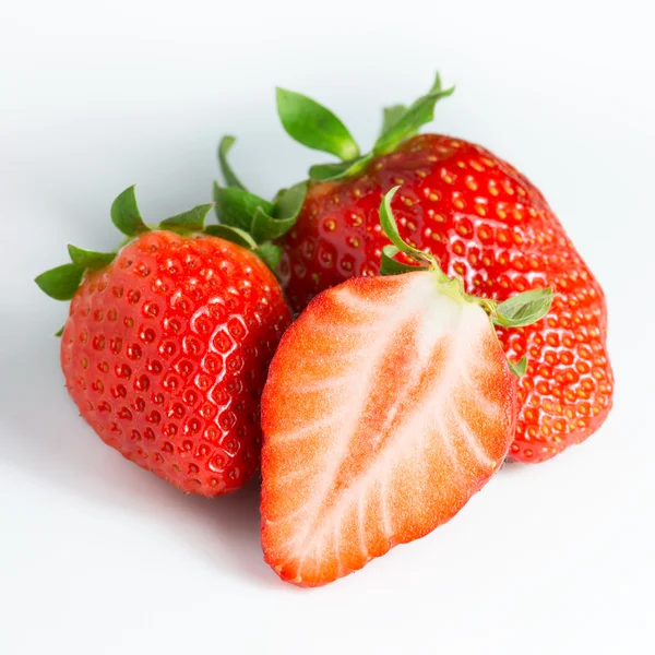 Strawberries and a half on white — Stock Photo, Image