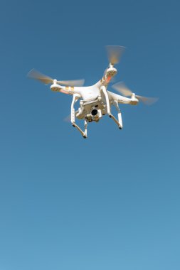 Flying drone with camera clipart
