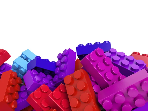 Barevné hračky plastové cihly pozadí — Stock fotografie