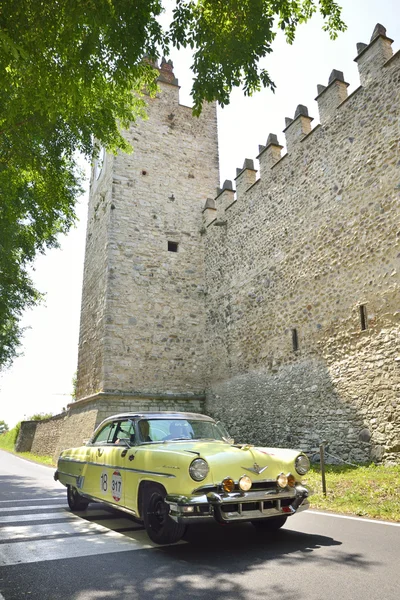 A yellow Lincoln Capri Sport Coupe takes part to the 1000 Miglia classic car race on May 17, 2015 in Passirano (BS). The car was built in 1954. — Stock Photo, Image