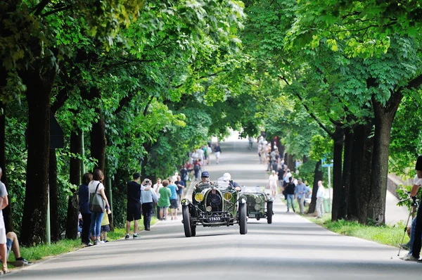 A green Bugatti T40 Grand Sport, followed by a green Aston Martin, takes part to the 1000 Miglia classic car race — Stock Photo, Image