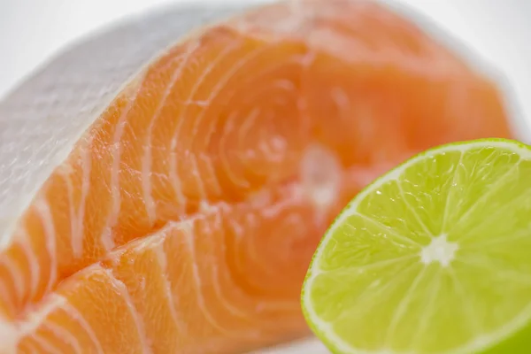Salmon steak with half of lime — Stock Photo, Image