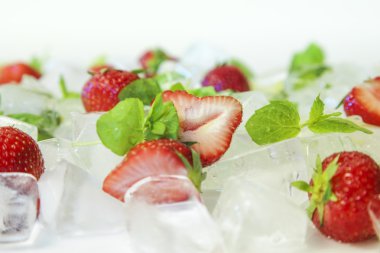 fresh strawberries with ice cubes refreshing background