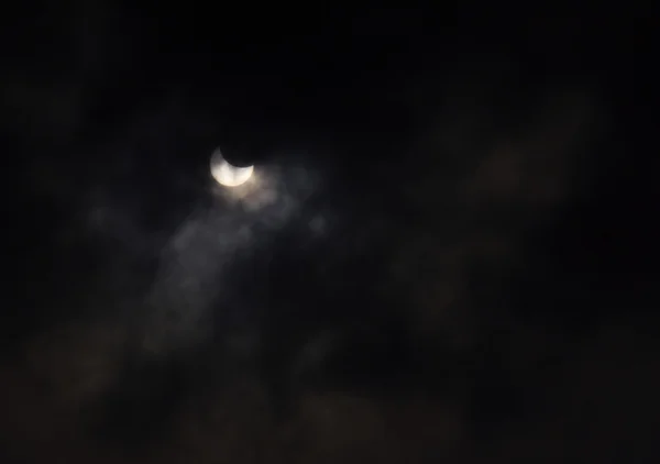 Eclipse solar parcial atrás das nuvens — Fotografia de Stock