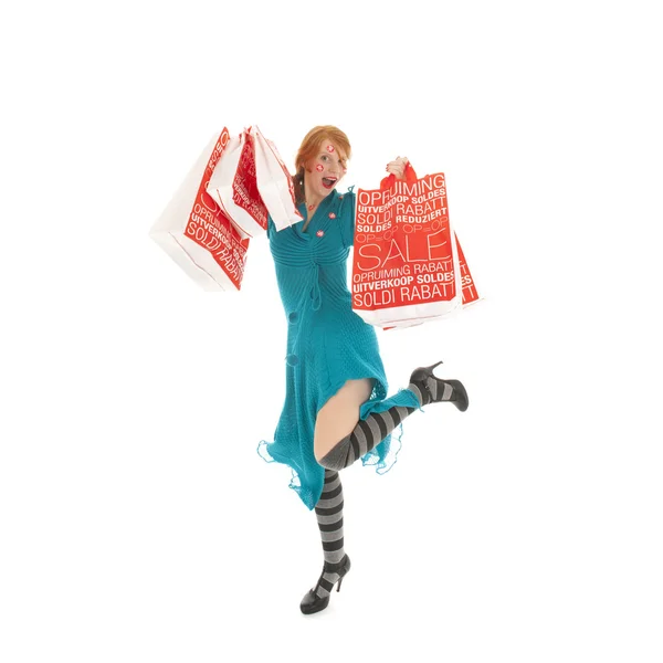 Woman jumping with sale shopping bags — Stock Photo, Image