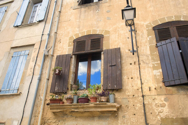 Typical French window with shutters and plants