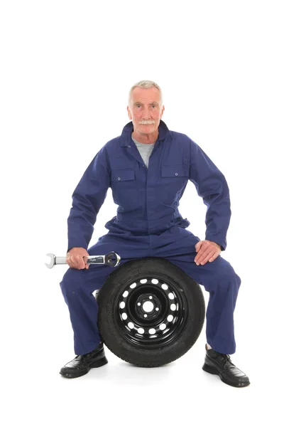 Mechanic with wheel and wrench — Stock Photo, Image