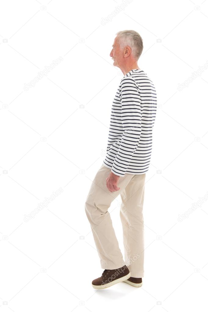 Senior man walking isolated over white background