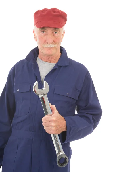 Man in blue overall with wrench — Stock Photo, Image