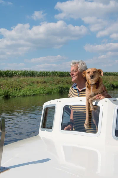Man and dog in boat — Stock Photo, Image
