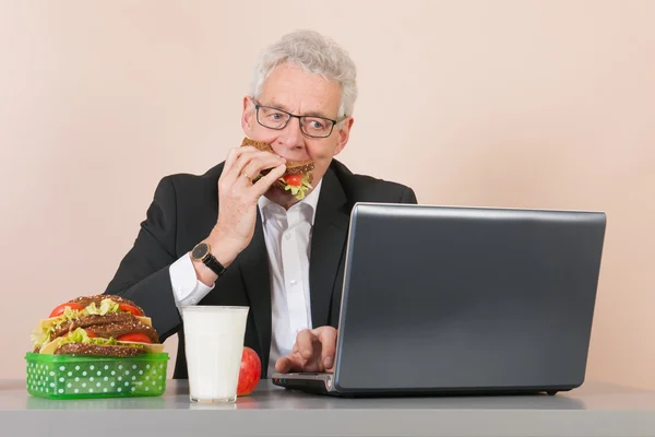 Senior man with lunch box at the office — Stock Photo, Image
