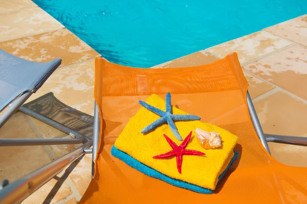 Värikäs tuolit uima-altaalla — kuvapankkivalokuva
