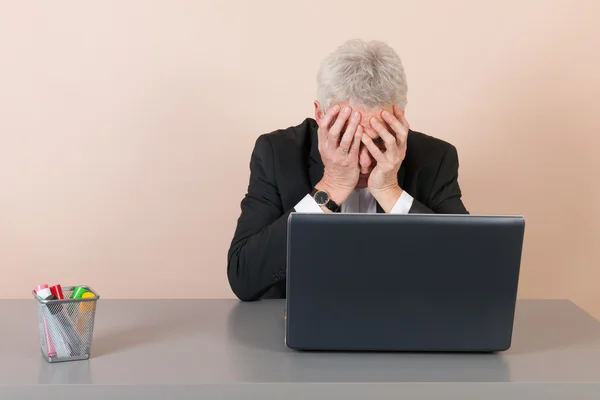 Senior man worried at the office — Stock Photo, Image